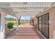A covered patio offers a seamless transition from indoor to outdoor living, complemented by desert landscaping at 5829 W Patrick Ln, Las Vegas, NV 89118