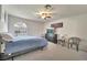 The bedroom features an arched window with plantation shutters, ceiling fan, and dresser at 5829 W Patrick Ln, Las Vegas, NV 89118