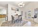 Cozy dining area with a chandelier, table setting, and lots of natural light from the French doors at 5829 W Patrick Ln, Las Vegas, NV 89118