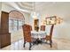 Dining area featuring a decorative chandelier, arched window and stylish furnishings at 5829 W Patrick Ln, Las Vegas, NV 89118