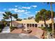Spacious single-story home with a circular driveway, mature trees, and a charming fountain at 5829 W Patrick Ln, Las Vegas, NV 89118