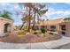Beautiful home exterior with desert landscaping, stone accents, and mature trees at 5829 W Patrick Ln, Las Vegas, NV 89118