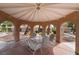 Covered gazebo features a charming space for outdoor dining, complete with a dining table and seating for six at 5829 W Patrick Ln, Las Vegas, NV 89118