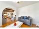 Charming living room with hardwood floors, neutral walls, comfortable seating, and open access to other rooms at 5829 W Patrick Ln, Las Vegas, NV 89118