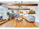 Spacious living room with a stone fireplace, hardwood floors, comfortable seating, and plenty of natural light at 5829 W Patrick Ln, Las Vegas, NV 89118