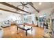 Inviting living room with hardwood floors, exposed wood beams, a stone fireplace, and comfortable seating at 5829 W Patrick Ln, Las Vegas, NV 89118