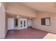 Covered patio with neutral color palette, dual ceiling fans, and access to the interior and exterior at 5829 W Patrick Ln, Las Vegas, NV 89118