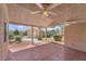 Covered patio featuring ceiling fans, textured concrete, and a view of the landscaped backyard at 5829 W Patrick Ln, Las Vegas, NV 89118