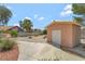 Backyard shed with landscaping and a concrete path, ideal for storage or a hobby space at 5829 W Patrick Ln, Las Vegas, NV 89118