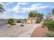 Well-maintained backyard shed with landscaping and a concrete walkway, perfect for storage at 5829 W Patrick Ln, Las Vegas, NV 89118