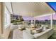 Spacious covered patio with outdoor seating, overlooking the pool, landscaping, and serene backyard at 62 Incline Village Ct, Henderson, NV 89074
