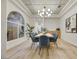 Stylish dining room with a large window, modern chandelier, and an open layout for entertaining at 62 Incline Village Ct, Henderson, NV 89074
