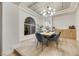 Chic dining area featuring a modern chandelier, light wood floors, and seamless flow to the rest of the home at 62 Incline Village Ct, Henderson, NV 89074