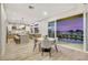 Kitchen with stainless steel appliances and island with dining area opening to pool area through sliding door at 62 Incline Village Ct, Henderson, NV 89074