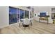 Open-concept living and dining area with hardwood floors, sliding glass doors, and plenty of natural light at 62 Incline Village Ct, Henderson, NV 89074