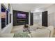Comfortable living area with a modern fireplace, mounted TV, and open view to upstairs at 62 Incline Village Ct, Henderson, NV 89074