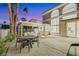 Outdoor patio with dining area, covered seating, and views of the home's architecture and sunset at 62 Incline Village Ct, Henderson, NV 89074