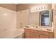 Clean bathroom with a tub and shower combination, vanity with sink, and large mirror with lights at 6480 Annie Oakley Dr # 624, Las Vegas, NV 89120