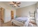 Cozy bedroom with ceiling fan, carpeted floors, and an ensuite bathroom, creating a private and comfortable living space at 6480 Annie Oakley Dr # 624, Las Vegas, NV 89120