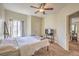Comfortable bedroom featuring a ceiling fan, carpeted floor, and ample natural light from the window at 6480 Annie Oakley Dr # 624, Las Vegas, NV 89120