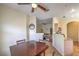 Cozy dining area featuring a wooden table set under a ceiling fan, adjacent to the kitchen and living area at 6480 Annie Oakley Dr # 624, Las Vegas, NV 89120