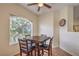 Bright dining area with a wooden table set next to a large window with natural light and outdoor views at 6480 Annie Oakley Dr # 624, Las Vegas, NV 89120