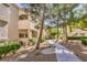 Landscaped walkway leading to a condo featuring a stucco facade and desert landscaping at 6480 Annie Oakley Dr # 624, Las Vegas, NV 89120