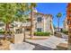 Exterior view of condo featuring desert landscaping, a stucco facade, and stairs at 6480 Annie Oakley Dr # 624, Las Vegas, NV 89120