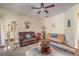 Bright living room with cozy seating, ceiling fan, and comfortable carpeting at 6480 Annie Oakley Dr # 624, Las Vegas, NV 89120