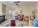 Comfortable living room with fireplace, ceiling fan and sliding glass doors to the patio at 6480 Annie Oakley Dr # 624, Las Vegas, NV 89120