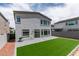 Well-maintained backyard with artificial grass, a brick patio, perfect for outdoor entertaining and relaxation at 681 Stone Hammer Ave, Las Vegas, NV 89183