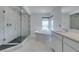 Beautiful bathroom showcasing a glass enclosed shower, a sleek tub next to a window, and a modern vanity at 681 Stone Hammer Ave, Las Vegas, NV 89183