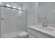Bright bathroom featuring a glass-enclosed shower, modern vanity, and neutral color palette at 681 Stone Hammer Ave, Las Vegas, NV 89183