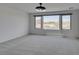 Bedroom with three large windows and neutral carpet at 681 Stone Hammer Ave, Las Vegas, NV 89183