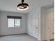 Bedroom featuring a modern ceiling fan, large window, and neutral carpet at 681 Stone Hammer Ave, Las Vegas, NV 89183