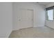 Cozy bedroom with neutral carpet, closet with sliding doors, and one window at 681 Stone Hammer Ave, Las Vegas, NV 89183