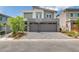 Contemporary two-story home featuring a two-car garage and landscaped front yard at 681 Stone Hammer Ave, Las Vegas, NV 89183