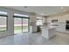 Modern white kitchen featuring stainless steel appliances and a center island overlooking the backyard at 681 Stone Hammer Ave, Las Vegas, NV 89183