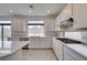 Contemporary kitchen with white cabinets, quartz countertops and stainless steel appliances at 681 Stone Hammer Ave, Las Vegas, NV 89183