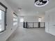 Spacious living room with large windows, modern railing, and neutral carpet at 681 Stone Hammer Ave, Las Vegas, NV 89183