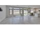 Bright living space with tile floors, large windows, and sliding glass doors to the backyard at 681 Stone Hammer Ave, Las Vegas, NV 89183
