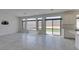 Bright living room featuring tile flooring, backyard access, and open concept to kitchen at 681 Stone Hammer Ave, Las Vegas, NV 89183