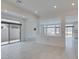 Spacious open living room with tile flooring, recessed lights, and backyard access at 681 Stone Hammer Ave, Las Vegas, NV 89183