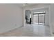 Bright living room with tile floors, recessed lighting, and sliding door to backyard at 681 Stone Hammer Ave, Las Vegas, NV 89183
