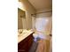 Standard bathroom with tub-shower combo, wood-finished vanity, and a toilet at 7089 Oberling Bay Ave, Las Vegas, NV 89113