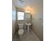 Compact bathroom with a pedestal sink and toilet, lit by a window at 7089 Oberling Bay Ave, Las Vegas, NV 89113