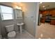 Cozy bathroom features a pedestal sink, toilet, and natural light from the window at 7089 Oberling Bay Ave, Las Vegas, NV 89113