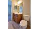 Clean bathroom features a vanity with mirror and a toilet near a doorway at 7089 Oberling Bay Ave, Las Vegas, NV 89113