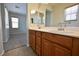 Bathroom with double sink vanity, neutral walls, and a shower-tub combo at 7089 Oberling Bay Ave, Las Vegas, NV 89113