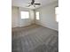 Carpeted bedroom offering neutral walls, multiple windows, and a ceiling fan at 7089 Oberling Bay Ave, Las Vegas, NV 89113
